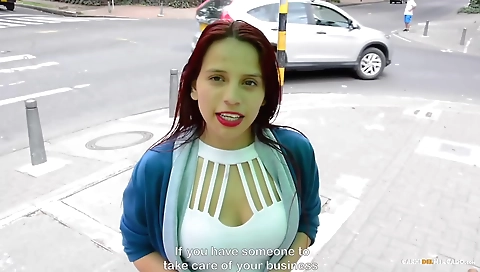 Red-haired woman with big tits is on the bed doing porn